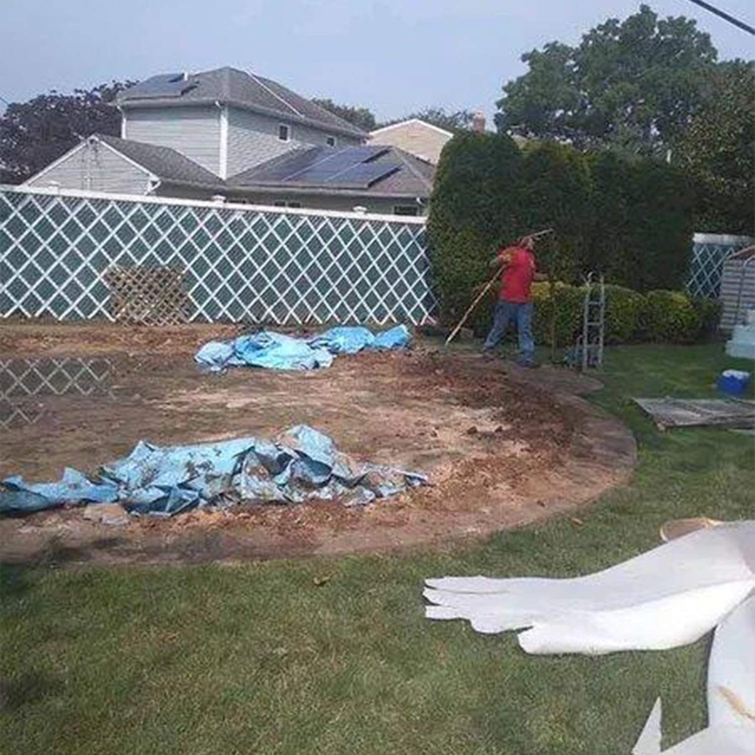 a man using a shovel in a yard