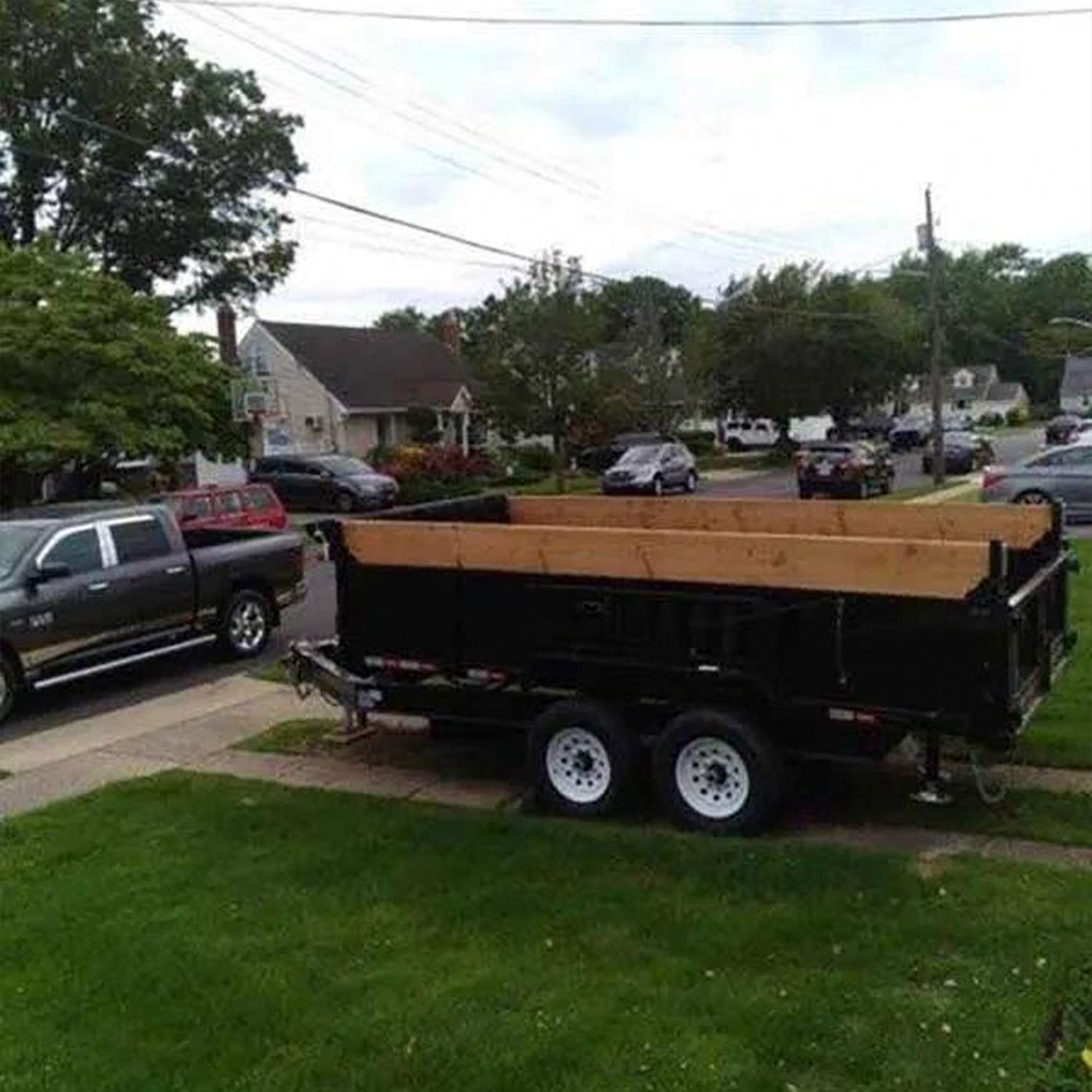 a black trailer with a wood board on the back