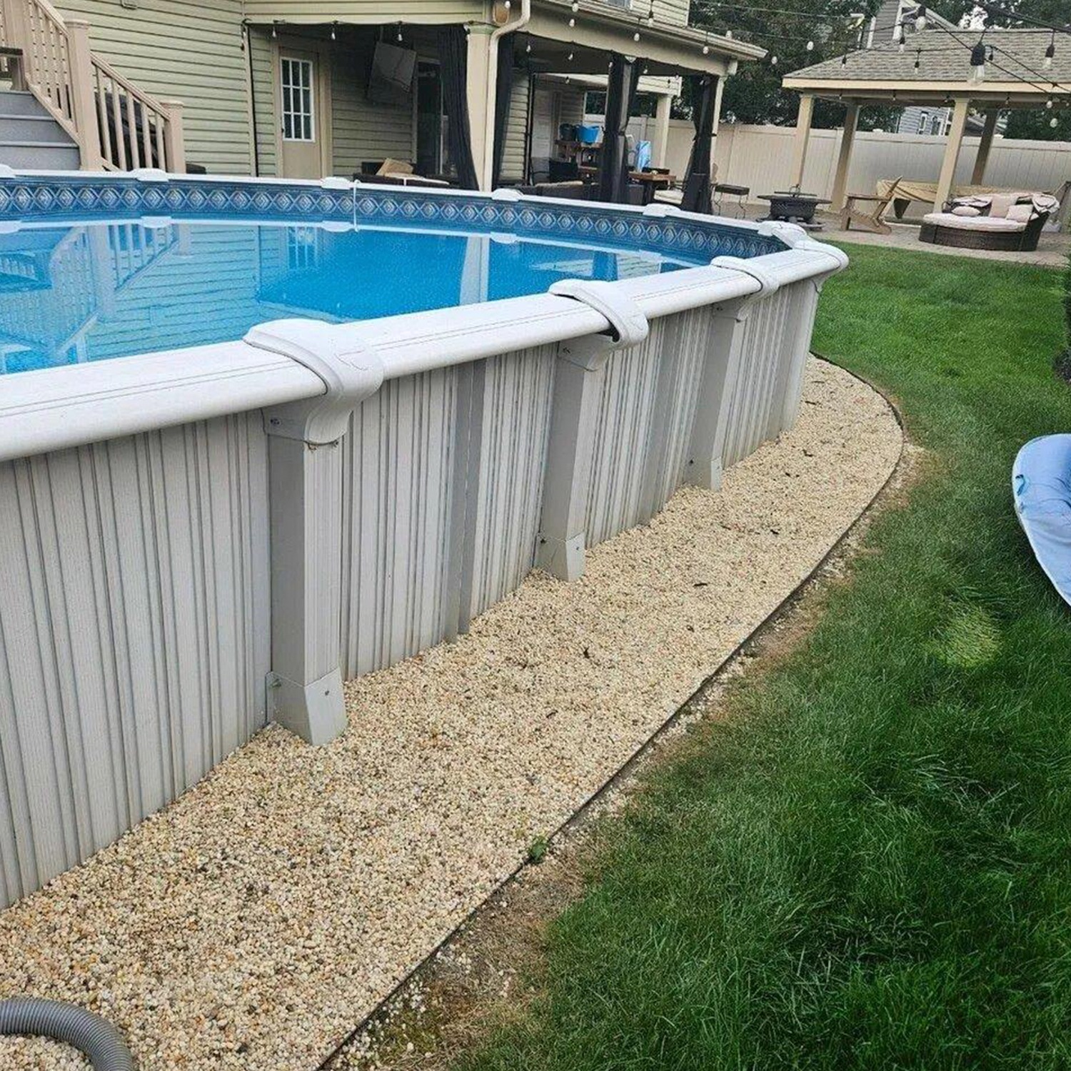 a pool with a lawn and a house
