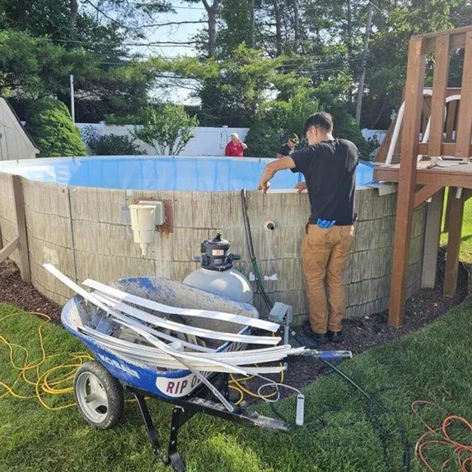 a man standing next to a pool